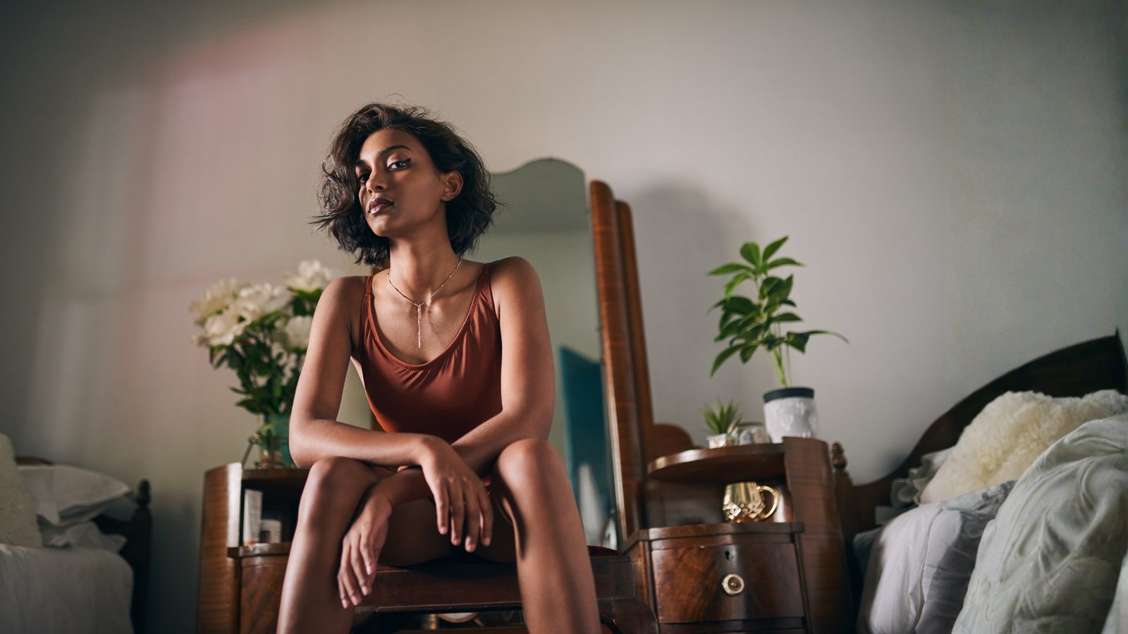 A woman sitting calmly in a softly lit room